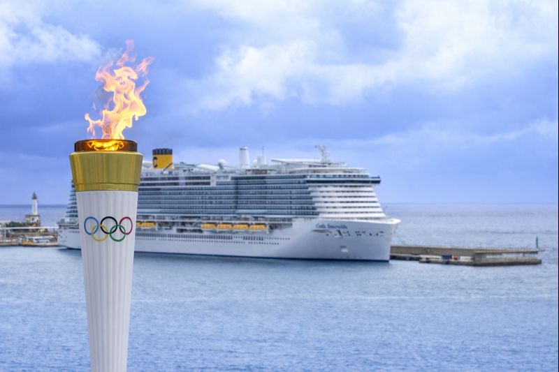 The Costa Smerelda cruise ship in dock with the Olympic flame in the foreground
