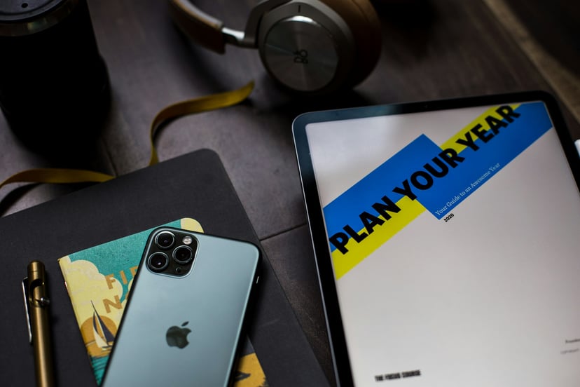 iPhone and tablet with 'paln your year' on the screen