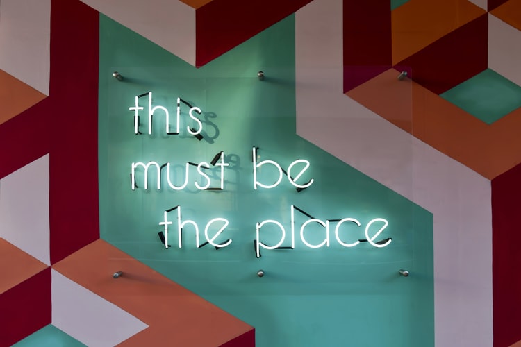 a neon sign that says 'this must be the place'