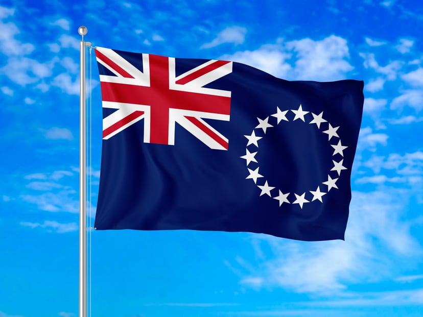 The flag of the Cook Islands against a blue sky