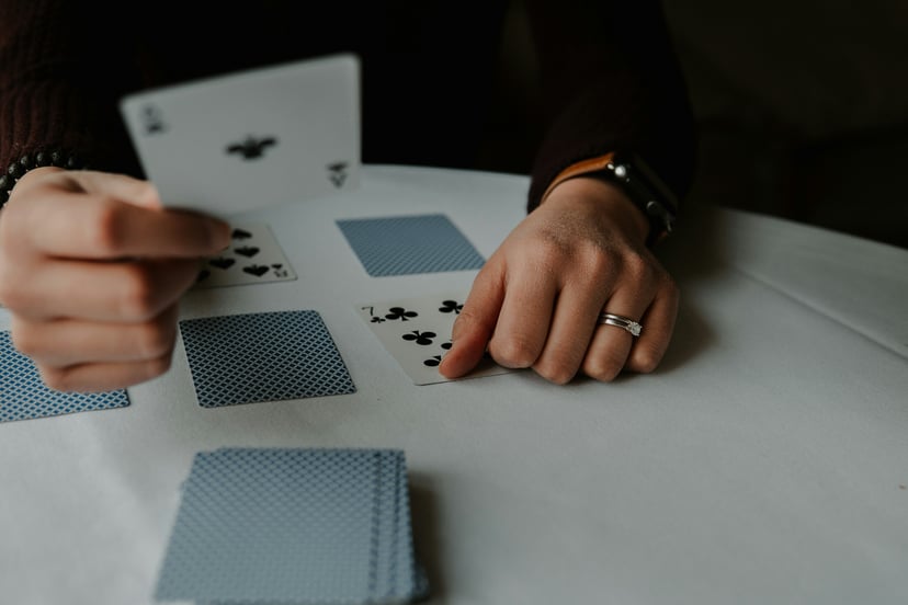 a person laying down playing cards