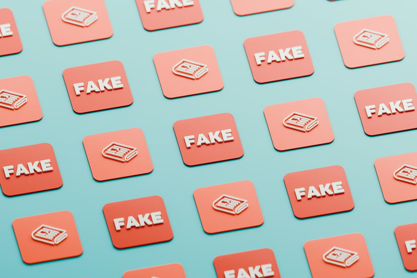 The word 'Fake' on pink tiles on a blue background