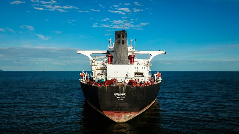 The bow of a cargo ship at sea with the superstructure clearly shown