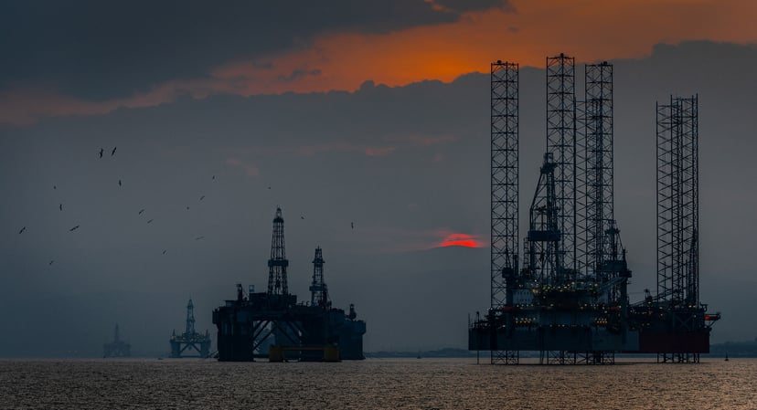 Offshore drilling rigs at sunset