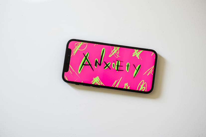a phone with the word 'anxiety' on the screen 