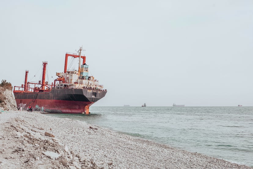 a grounded cargo ship on a beach