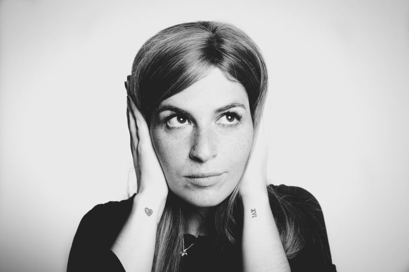 woman with her hands over her ears