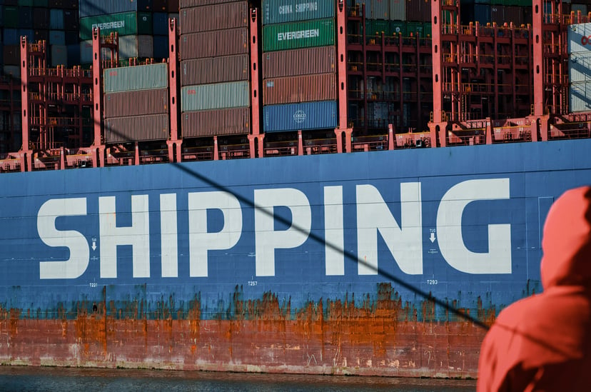 The word 'shipping' on the side of a Cosco Shipping vessel
