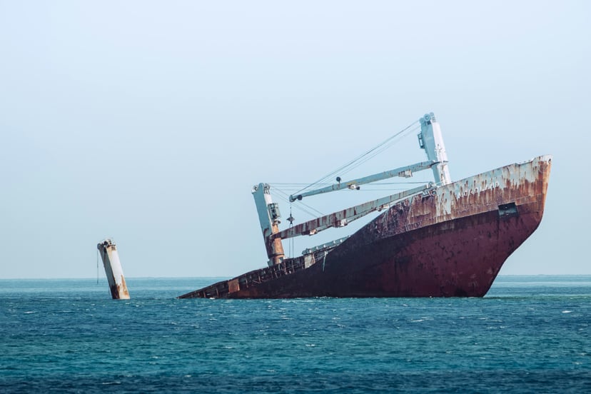 a sinking bulk carrier half submerged in water