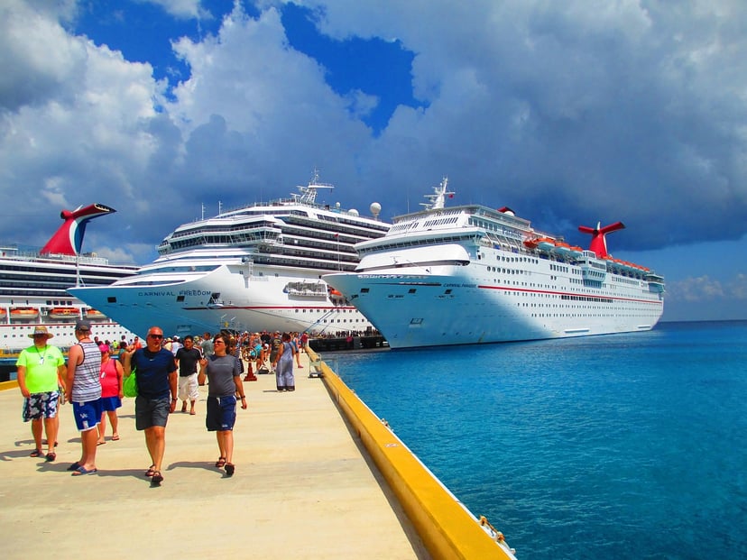 The Carnival Freedom cruise ship moored next to another vessel