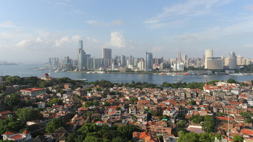 Xiamen, China with the old city in the foreground and new skyscrapers across the water in the background