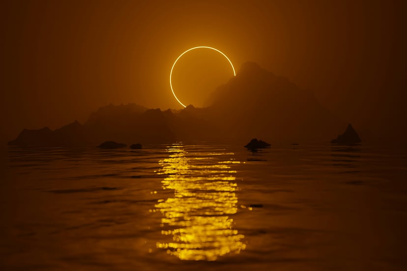 A solar eclipse reflected on a shimmering body of water