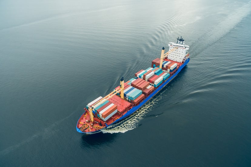 aerial view of a container ship in the middle of the ocean