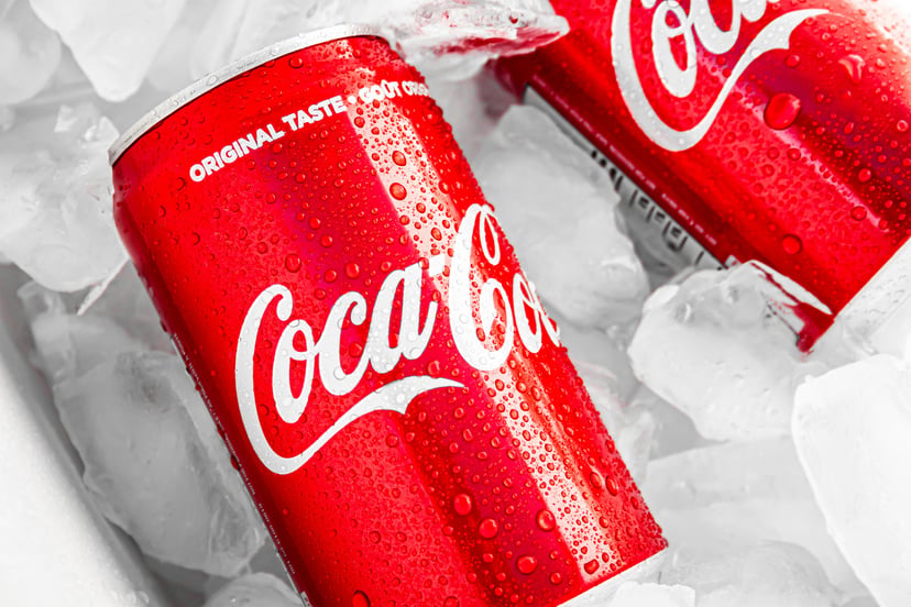 two cans of Cocoa-Cola on ice