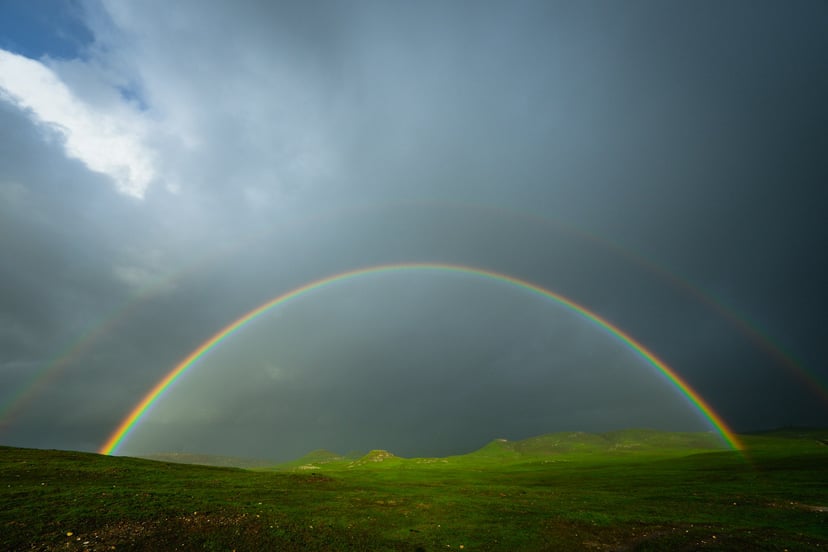 A rainbow under a gloomy sky