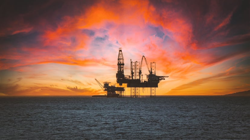 An offshore oil rig at sundown