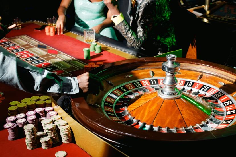 Players at a roulette table in a casino 