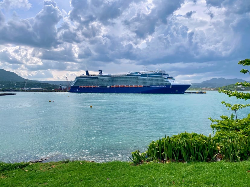 The Celebrity Reflection cruise ship near land and under a cloudy sky