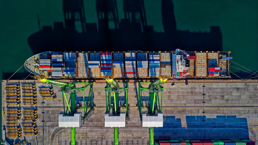 an aerial view of a container ship being loaded in port