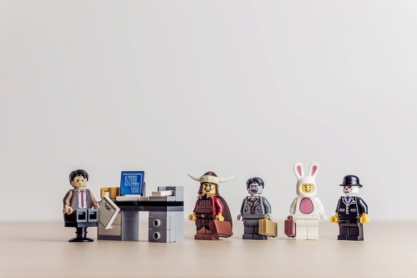 Leo figures in different costumes lining up to speak to their manager