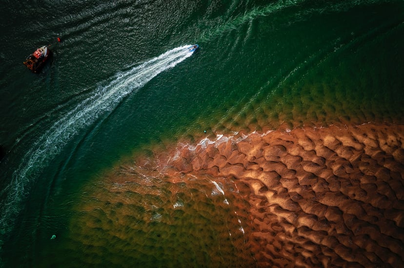 Aerial view of a powerboat and its wake