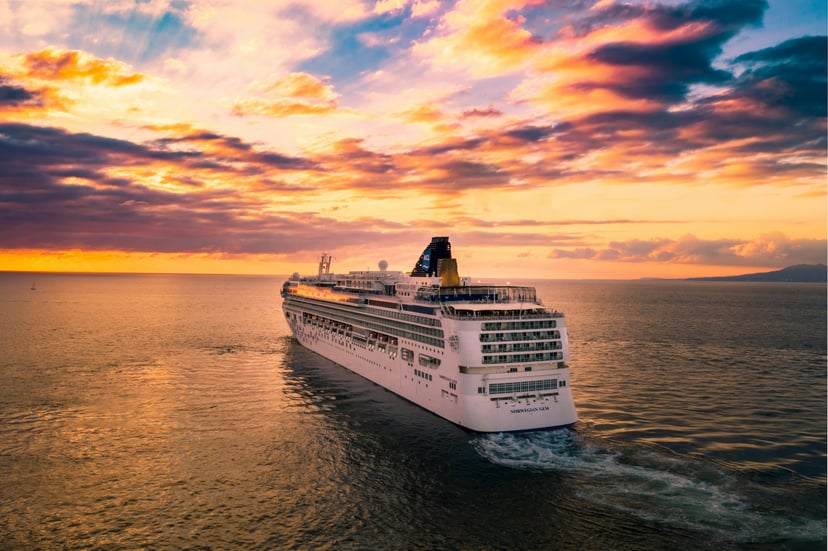 The Norwegian Gem cruise ship at sea at sunset