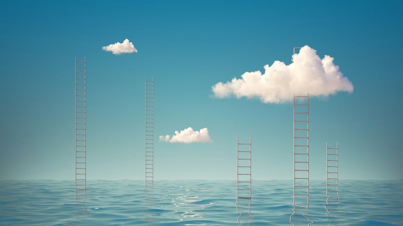 Ladders rising up out of the ocean towards a blue sky