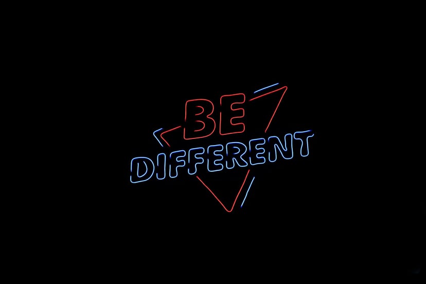 Neon sign saying 'be different'