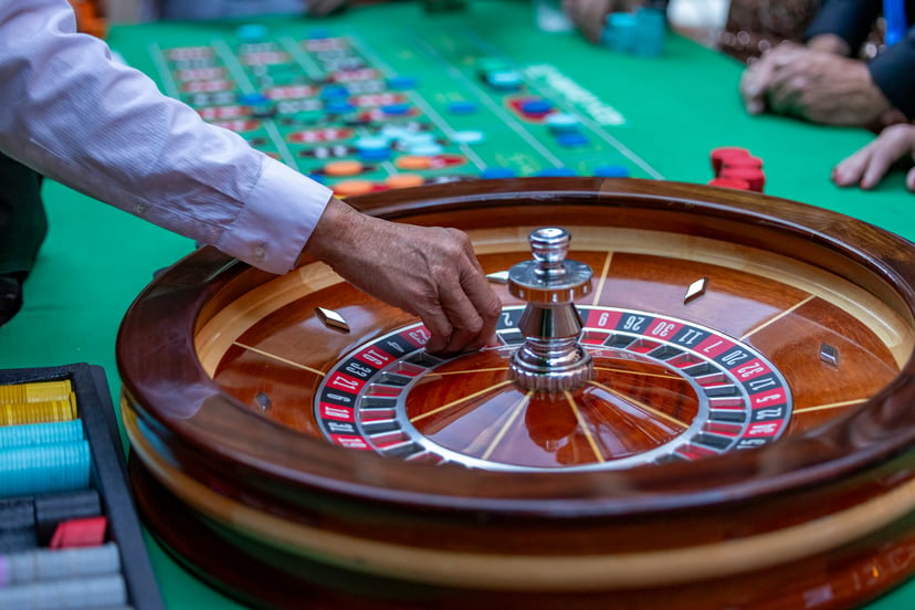 A croupier placing the ball on a roulette wheel