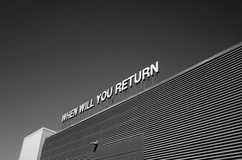 A sign on a roof that says 'when will you return'