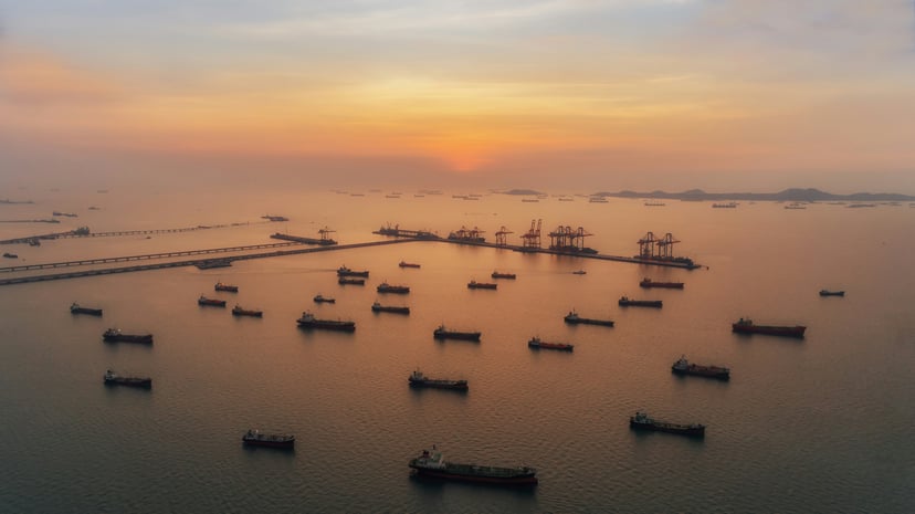 Oil tankers moored at sunset