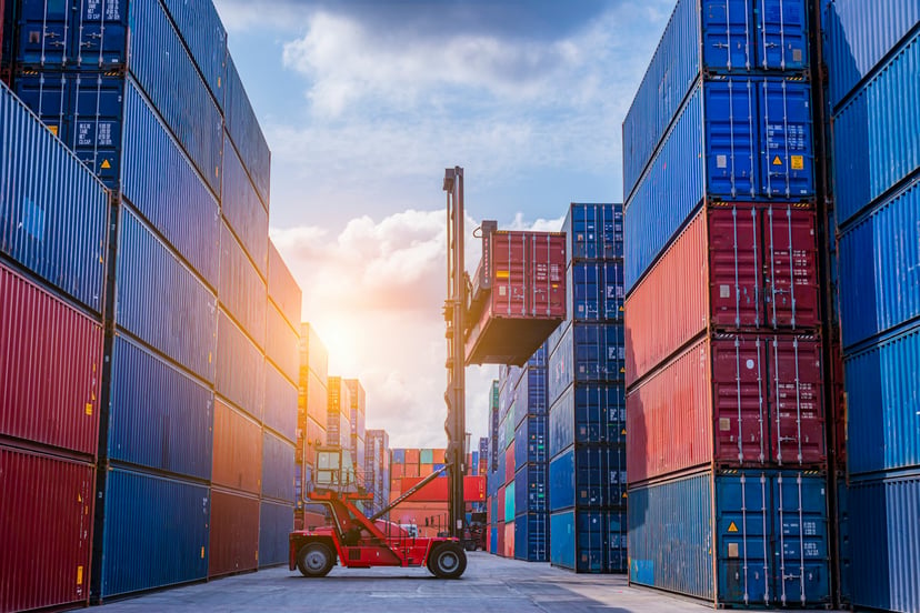 Red and blue shipping containers in a port