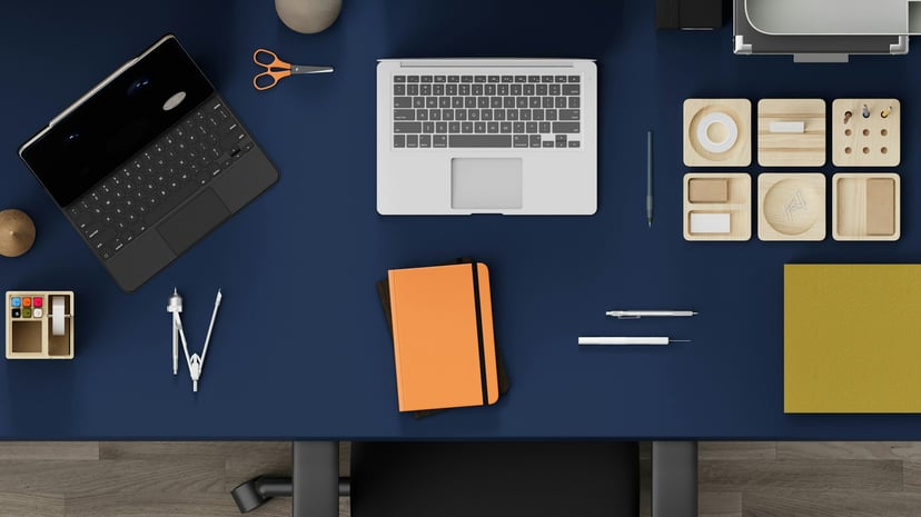 Laptops, compass, notebook and other tools on a desk