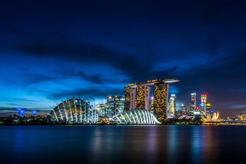 a view of Singapore at night across the water
