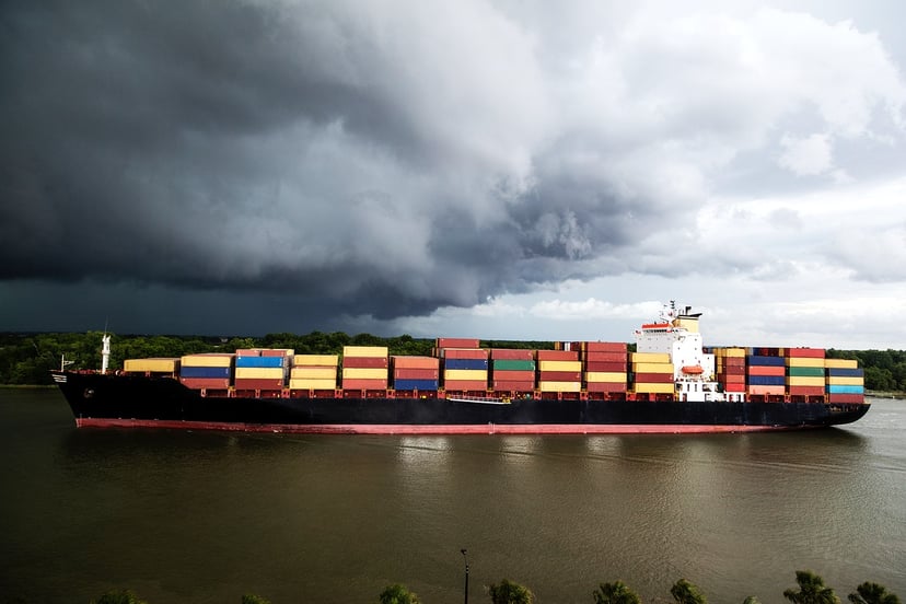 a container ship under a dark stormy sky