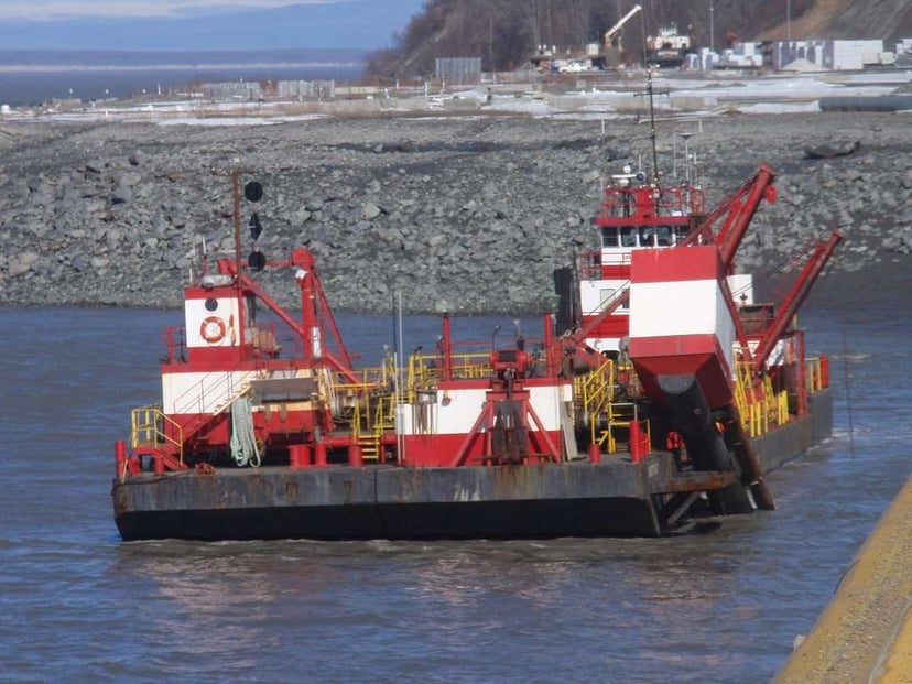 a red and white dredger