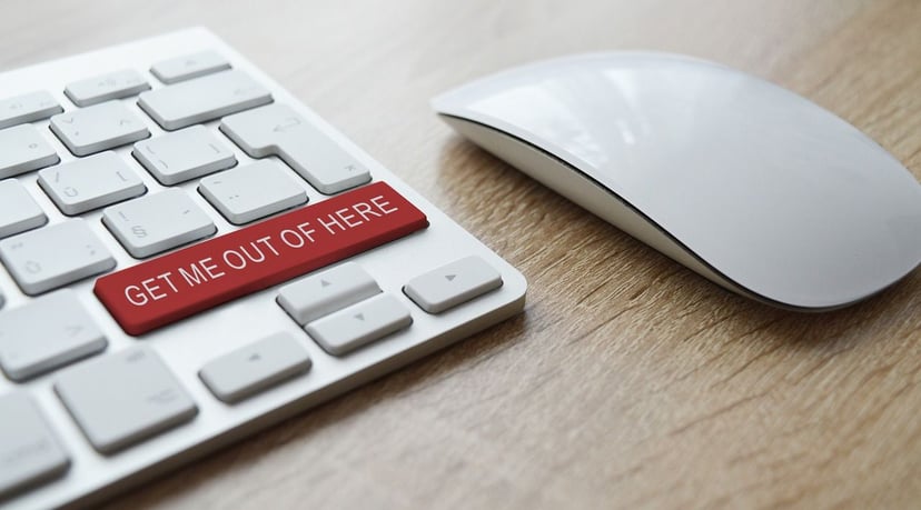 a computer keyboard with a big red button that says 'Get me out of here' on it