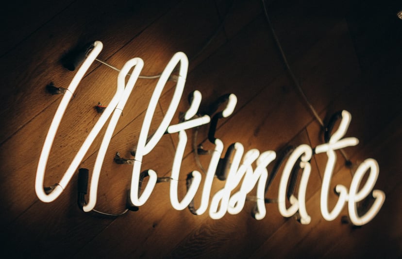 A neon sign saying 'ultimate'