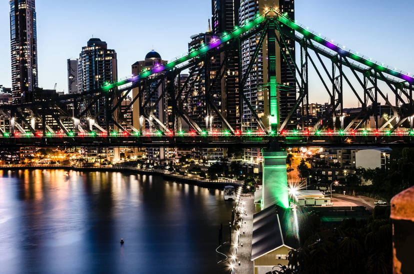 Christmas lights on a harbor bridge as seen from a vessel