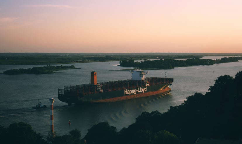 A Hapag-Lloyd container ship at sea at sunset