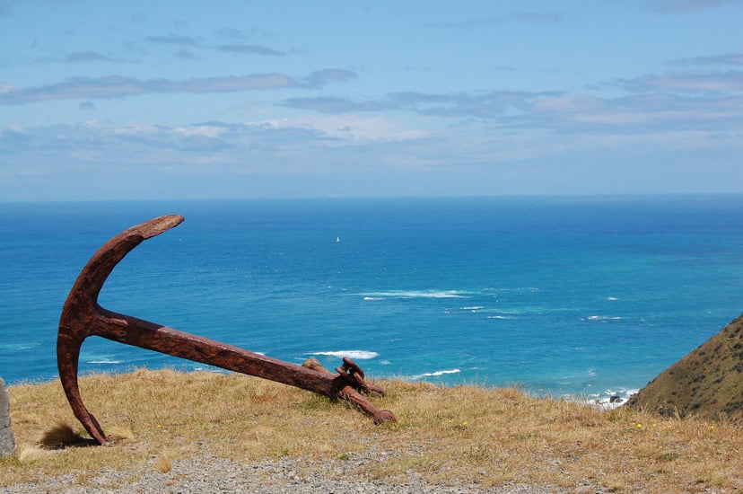 an anchor on a cliff overlooking the sea