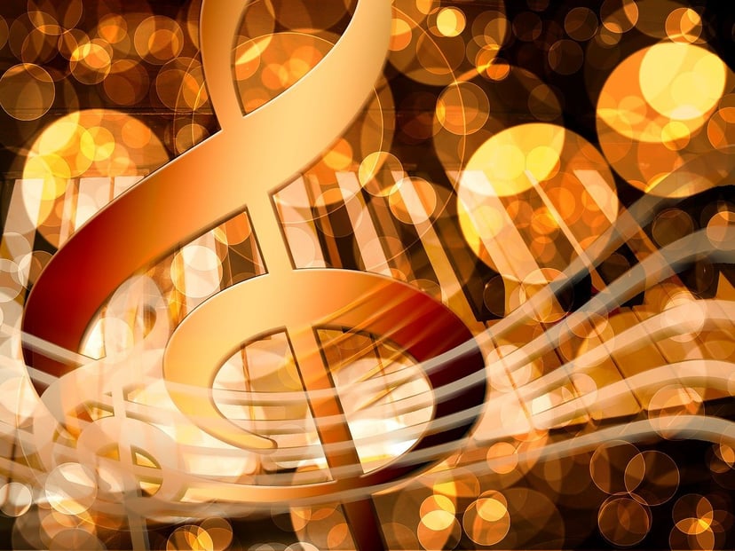 A golden treble clef and piano keys