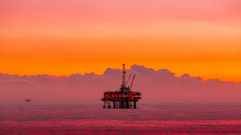 An offshore oil rig at sunset