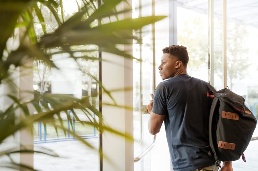 Man with backpack leaving an office
