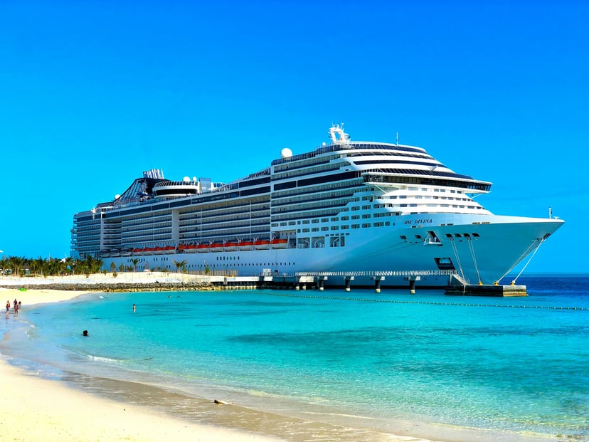The MSC Divinia moored at a tropical beach