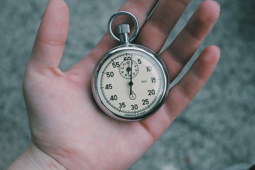 a stopwatch in a person's palm