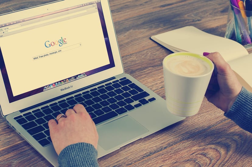 person using a laptop to conduct a Google search
