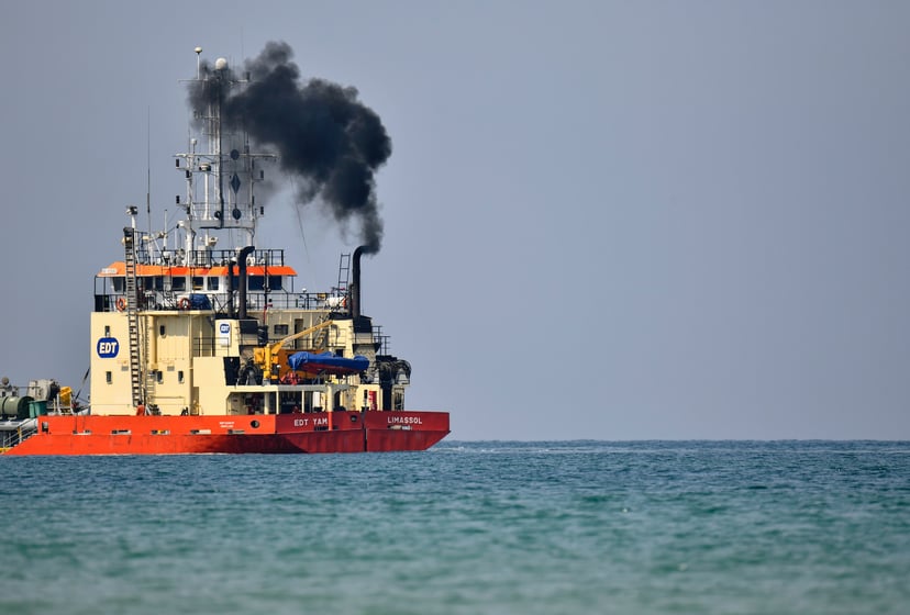 a dredger emitting fumes