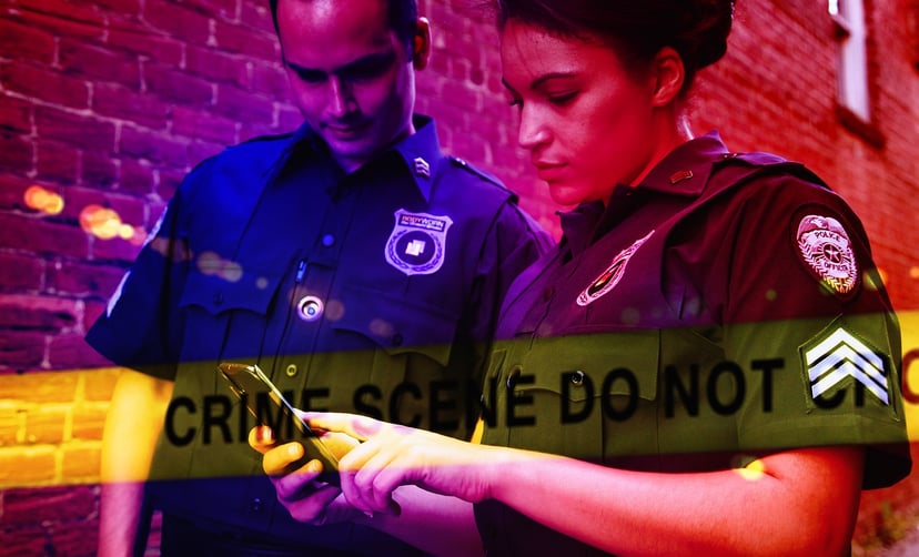 two cops looking at a phone with a crime scene banner super-imposed across them