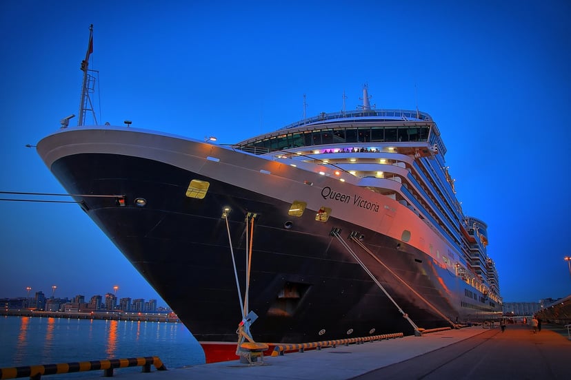 Cunard's Queen Victoria cruise ship moored at a dock at night